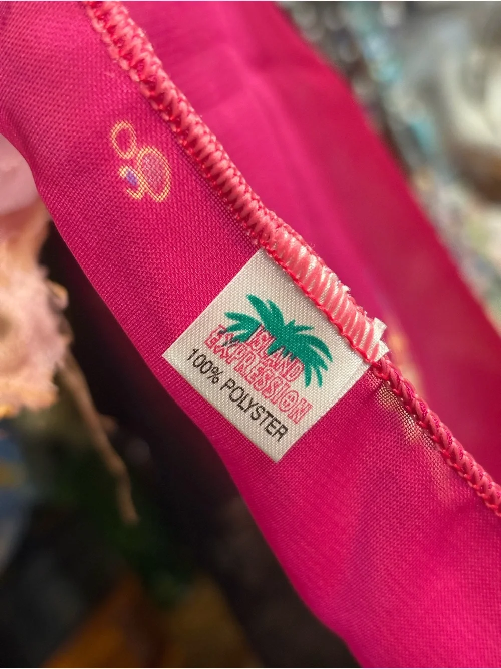 magenta and black scarf features palm tree motifs and black tassels along the ed